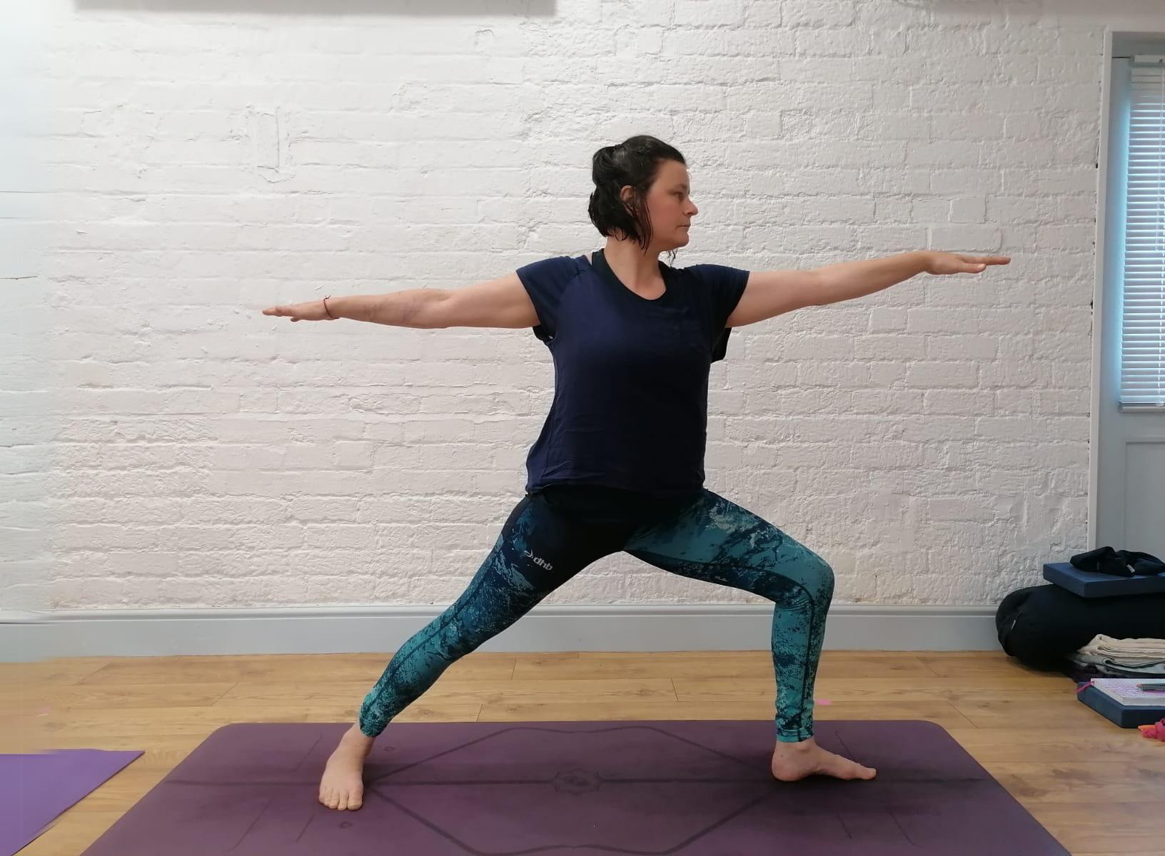 Rachel, founder of Open Skies Yoga in Warrior two Yoga pose